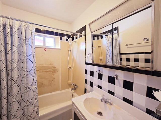 full bathroom featuring shower / bath combination with curtain and vanity