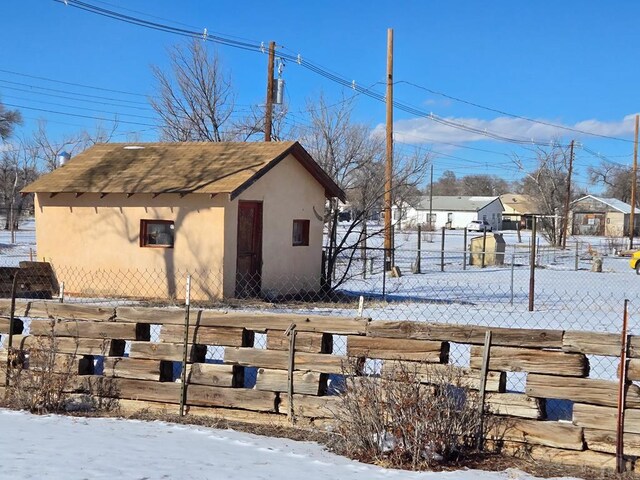 snowy yard with fence