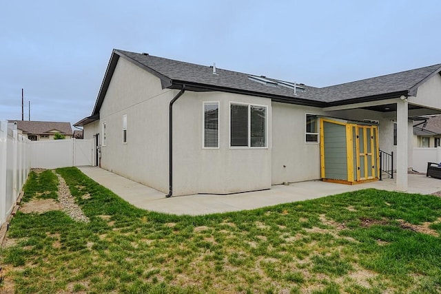 2221 Cliffmoor Ln, Pueblo, CO 81008 - rear view of house with a patio, stucco siding, and roof with shingles