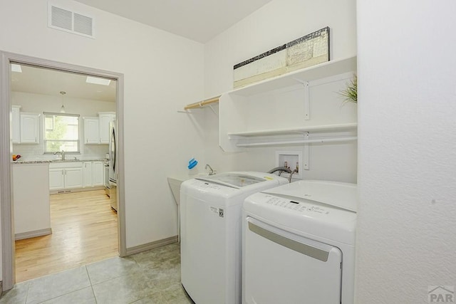 2221 Cliffmoor Ln, Pueblo, CO 81008 - washroom featuring independent washer and dryer and light tile patterned floors