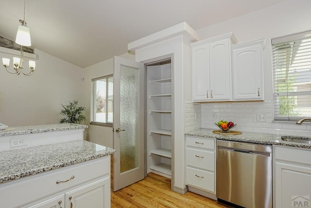 2221 Cliffmoor Ln, Pueblo, CO 81008 - kitchen featuring dishwasher, white cabinetry, light wood-style floors, and light stone counters
