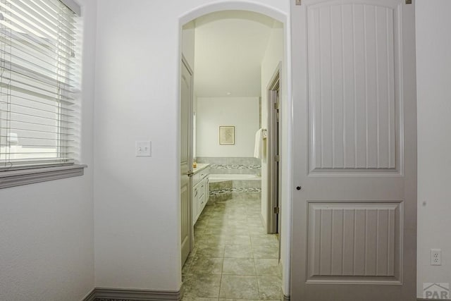 2221 Cliffmoor Ln, Pueblo, CO 81008 - corridor featuring light tile patterned floors and arched walkways