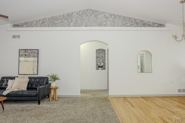 2221 Cliffmoor Ln, Pueblo, CO 81008 - living room with vaulted ceiling, baseboards, and arched walkways