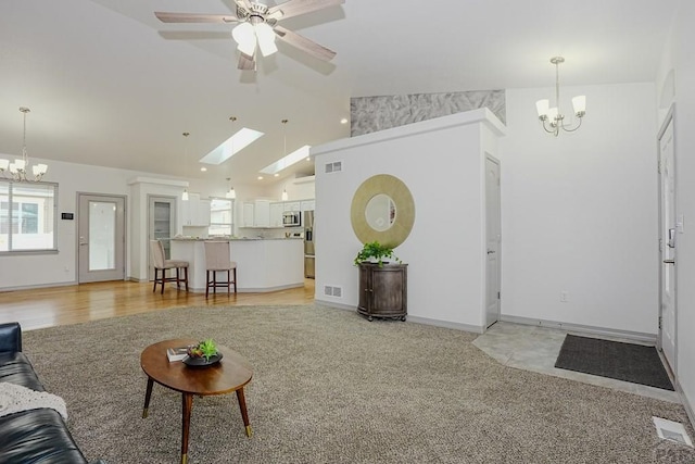 2221 Cliffmoor Ln, Pueblo, CO 81008 - living area with a chandelier, vaulted ceiling, light colored carpet, ceiling fan, and baseboards