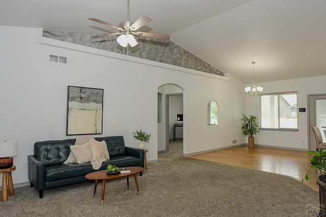 2221 Cliffmoor Ln, Pueblo, CO 81008 - living room with arched walkways, a chandelier, ceiling fan, carpet flooring, and high vaulted ceiling