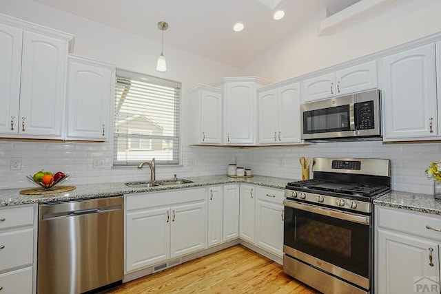 2221 Cliffmoor Ln, Pueblo, CO 81008 - kitchen with appliances with stainless steel finishes, a sink, white cabinets, backsplash, and recessed lighting