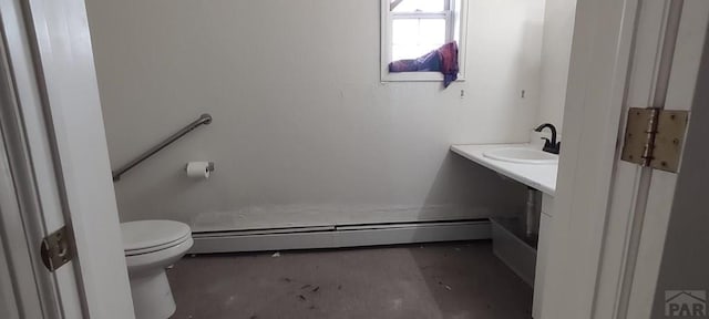 bathroom with a baseboard heating unit, a sink, and toilet