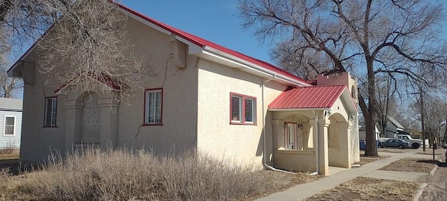 view of property exterior featuring metal roof and stucco siding