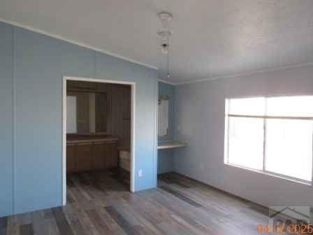 326 Katherine St, Avondale, CO 81022 - unfurnished bedroom featuring wood finished floors and vaulted ceiling