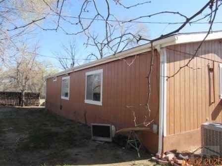 326 Katherine St, Avondale, CO 81022 - view of side of home featuring central AC unit and fence