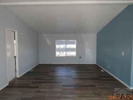 326 Katherine St, Avondale, CO 81022 - bonus room featuring vaulted ceiling and wood finished floors