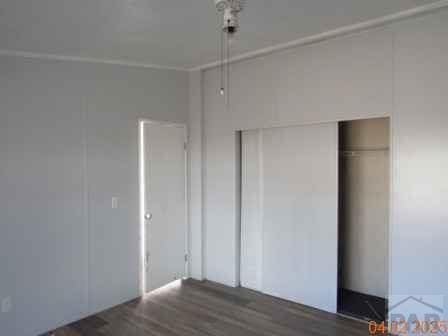 326 Katherine St, Avondale, CO 81022 - unfurnished bedroom with a closet and wood finished floors