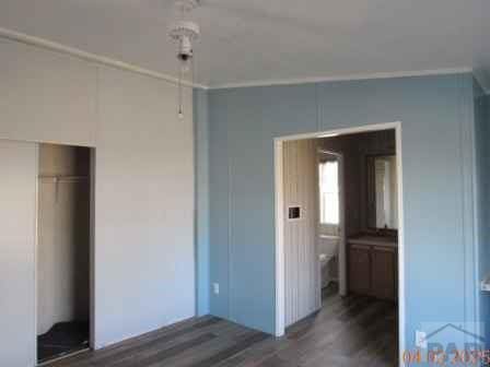 326 Katherine St, Avondale, CO 81022 - unfurnished bedroom featuring a closet and wood finished floors