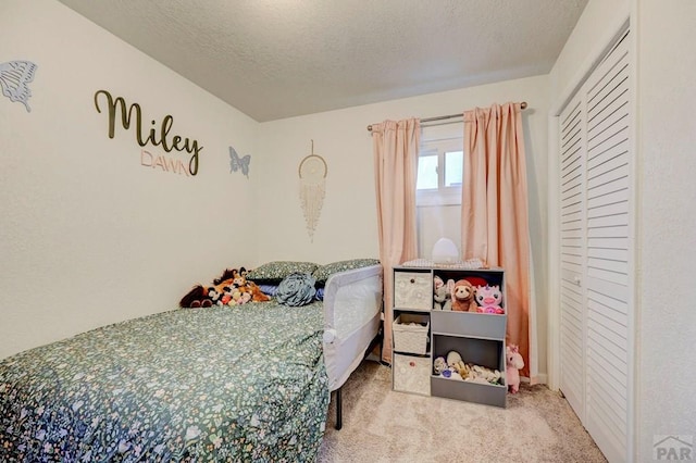 carpeted bedroom with a textured ceiling