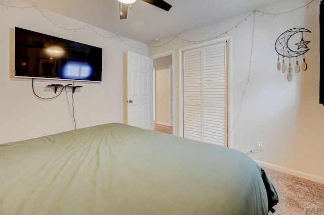 unfurnished bedroom with carpet floors, a closet, ceiling fan, and baseboards