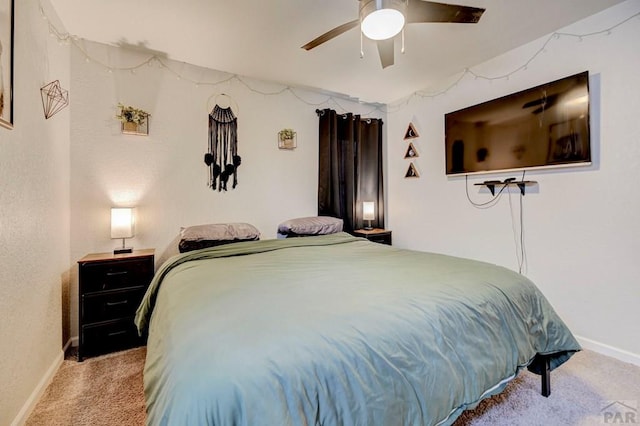 carpeted bedroom with baseboards and a ceiling fan