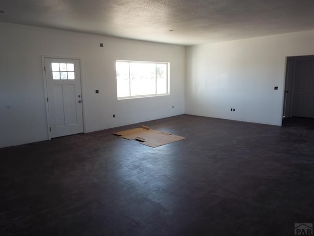 entryway with a textured ceiling and dark wood-style flooring