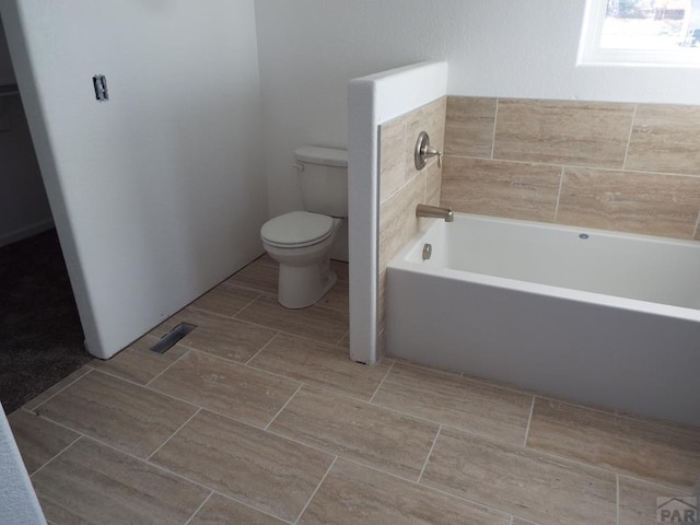 full bathroom with visible vents, toilet, and a bath