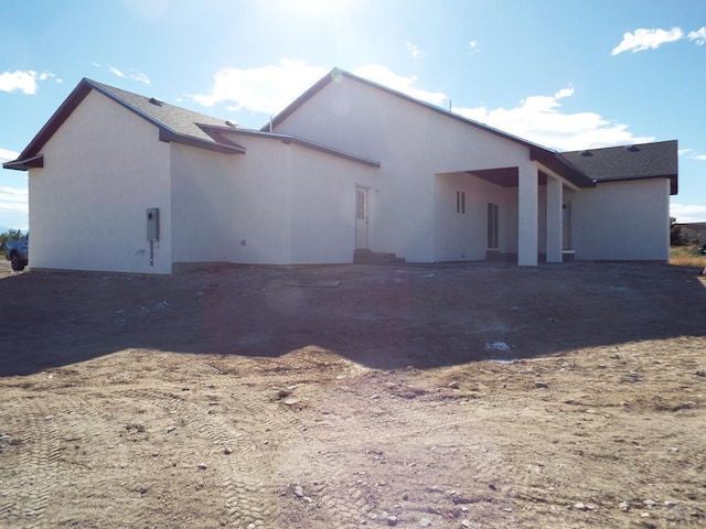 back of property with stucco siding