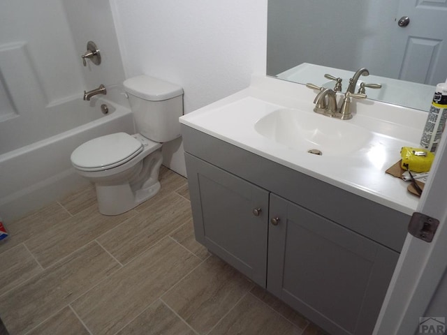 full bath featuring shower / bathtub combination, vanity, toilet, and wood tiled floor