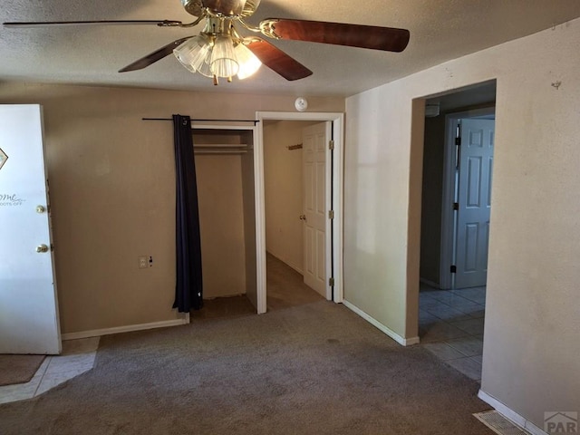 209 5th St, Fowler, CO 81039 - unfurnished bedroom featuring carpet, a ceiling fan, and tile patterned floors