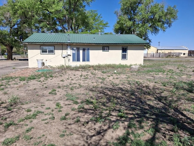 209 5th St, Fowler, CO 81039 - rear view of property with stucco siding and metal roof