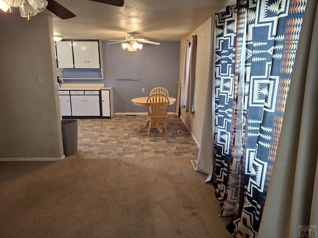 209 5th St, Fowler, CO 81039 - dining space with a ceiling fan, baseboards, and carpet floors