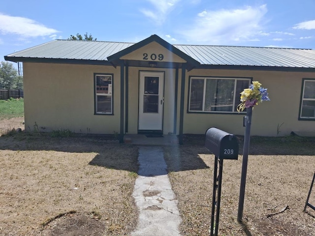 209 5th St, Fowler, CO 81039 - view of front of house with stucco siding and a metal roof