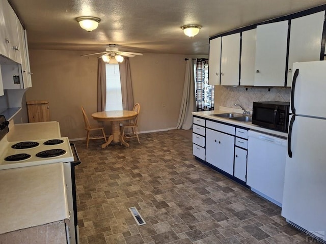 209 5th St, Fowler, CO 81039 - kitchen with white appliances, backsplash, ceiling fan, and plenty of natural light