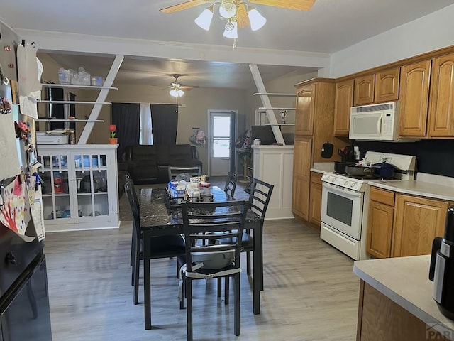 900 Van Buren St, Pueblo, CO 81004 - kitchen with white appliances, a ceiling fan, light wood-style flooring, light countertops, and brown cabinets
