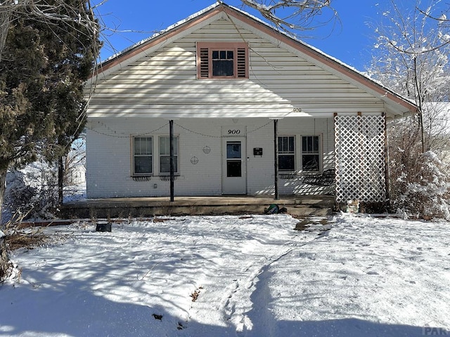 view of front of property with a porch and brick siding