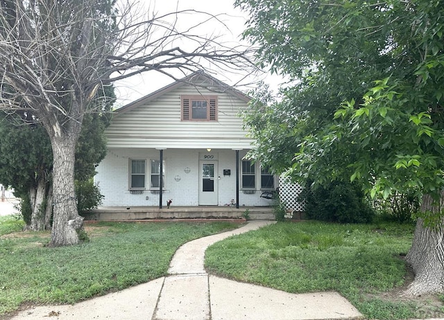 900 Van Buren St, Pueblo, CO 81004 - view of front of home with brick siding, covered porch, and a front lawn
