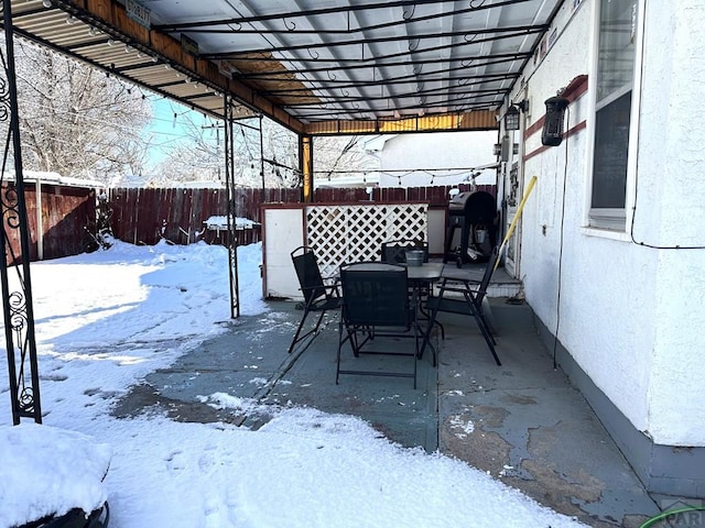 900 Van Buren St, Pueblo, CO 81004 - snow covered patio with a fenced backyard, outdoor dining area, and a patio