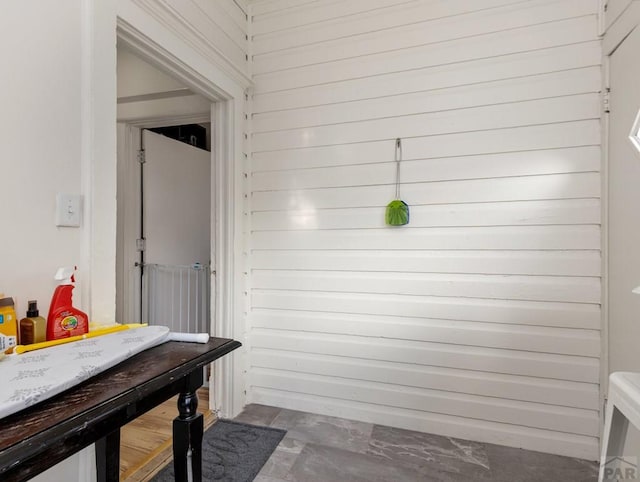 mudroom featuring wood walls