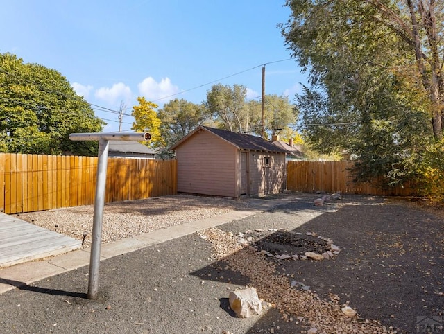 garage featuring a shed and fence