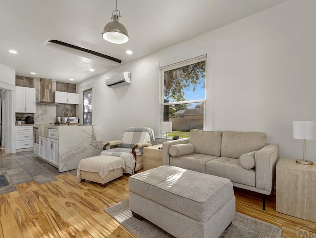 living room featuring light wood-type flooring, recessed lighting, and a wall mounted AC