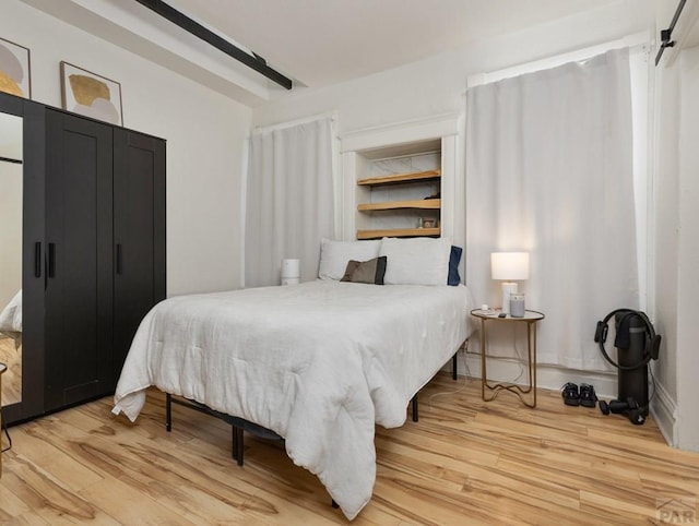 bedroom with wood finished floors