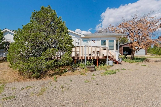 back of house featuring a wooden deck