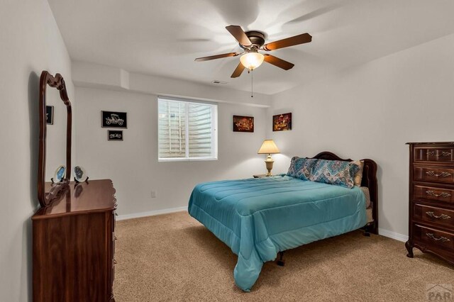 bedroom with visible vents, baseboards, ceiling fan, and light colored carpet