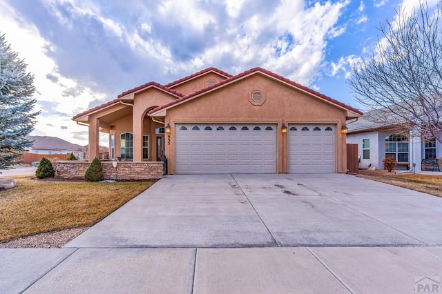 view of front of house with a garage, concrete driveway, a tiled roof, and stucco siding