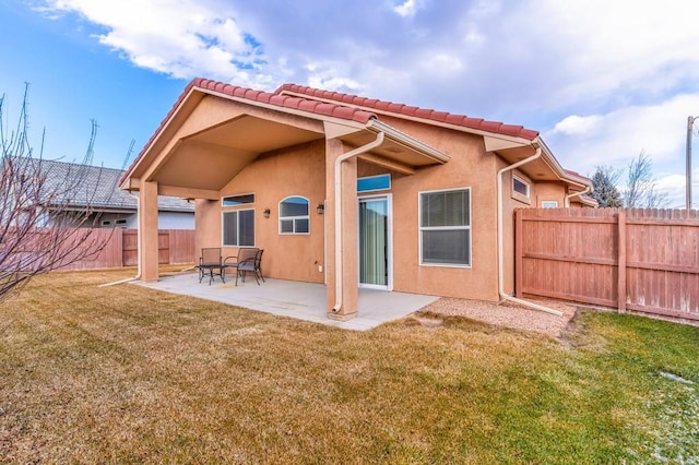 back of property featuring a patio, a yard, a fenced backyard, and stucco siding