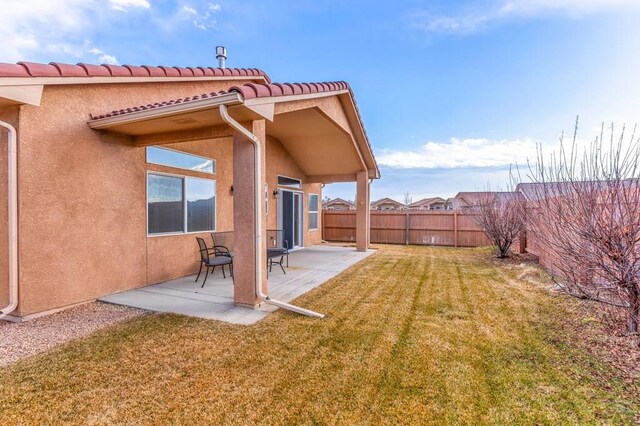 view of yard with a patio area and a fenced backyard