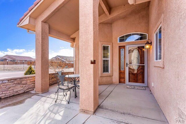 doorway to property with a patio and stucco siding