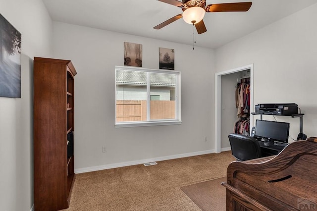 interior space featuring carpet floors, a ceiling fan, and baseboards