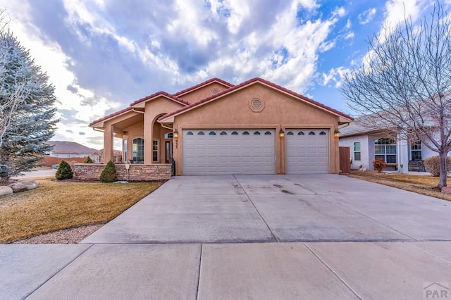 view of front of house featuring an attached garage, driveway, and stucco siding