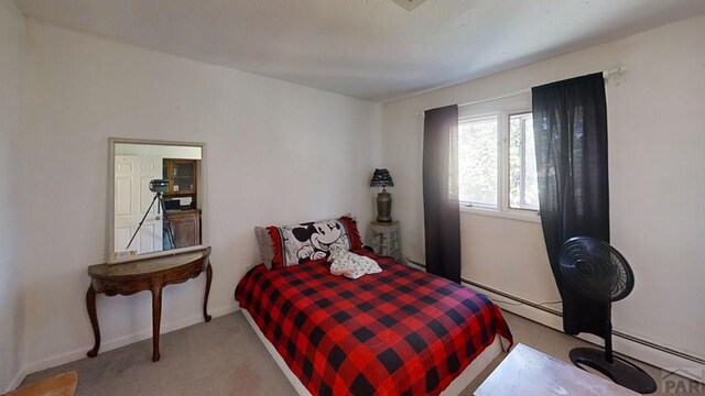 bedroom with a baseboard radiator, light carpet, and baseboards