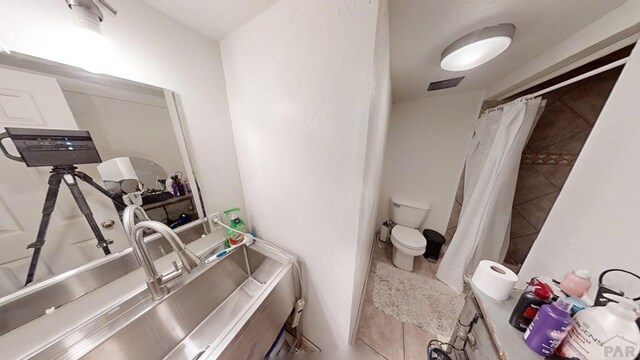 full bath with toilet, tile patterned flooring, and visible vents