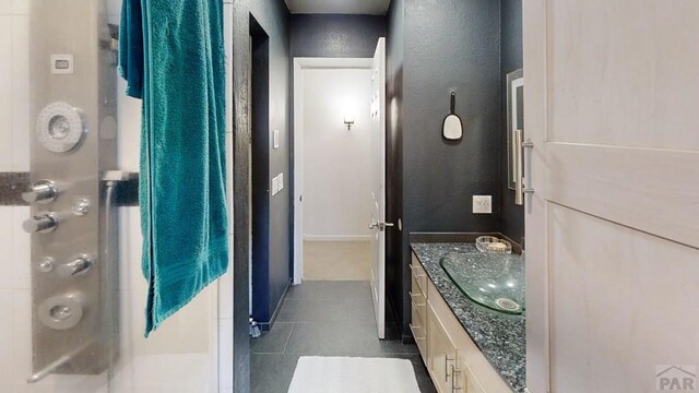 full bath with tile patterned floors and vanity