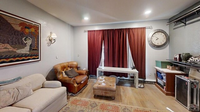 living area with recessed lighting and light wood-style flooring