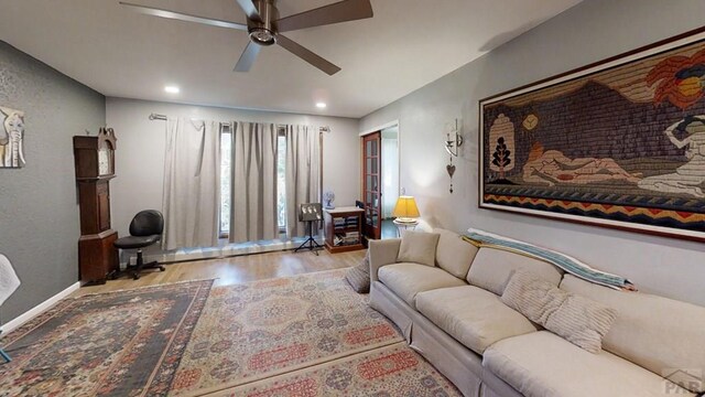 living area featuring baseboards, recessed lighting, light wood-style flooring, and a ceiling fan